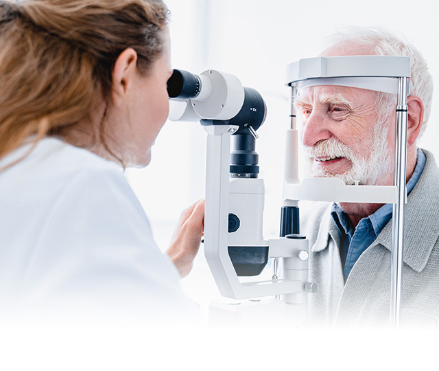  A woman placing a contact lens into her left eye.