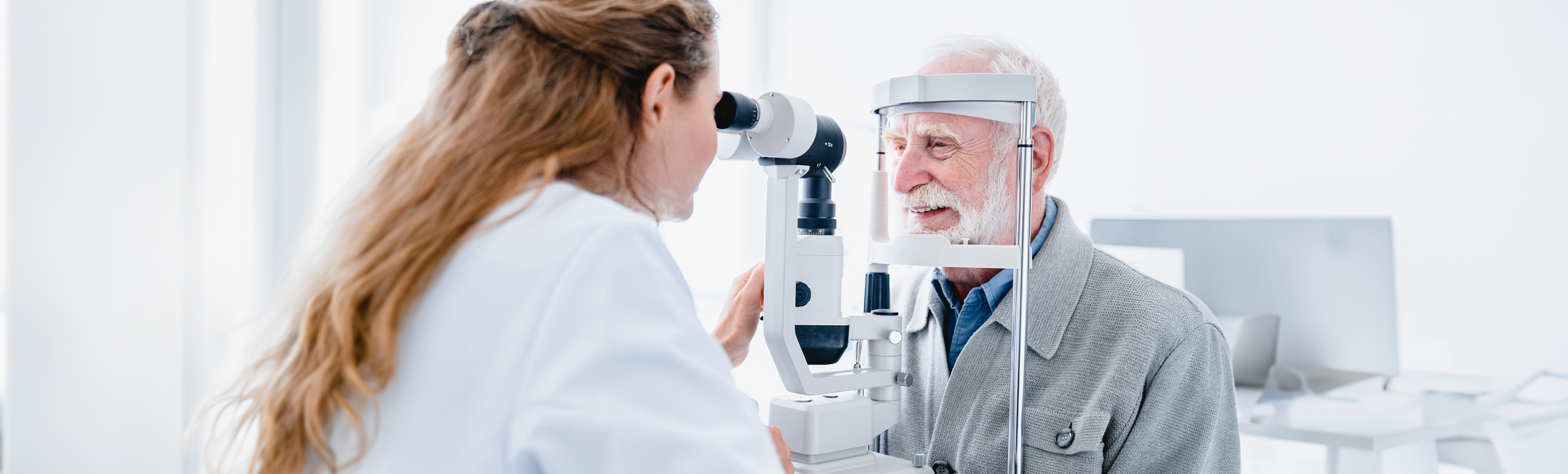  A woman placing a contact lens into her left eye.